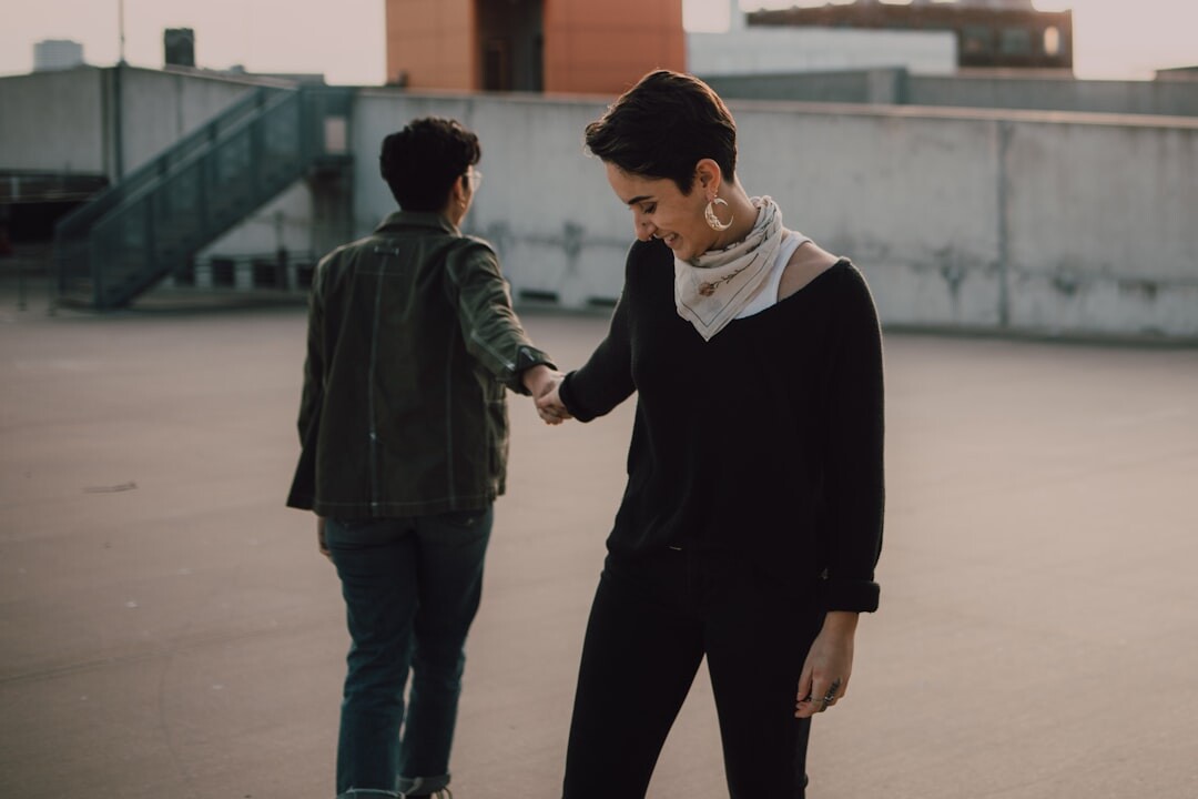 Two colleagues shaking hands after resolving a conflict